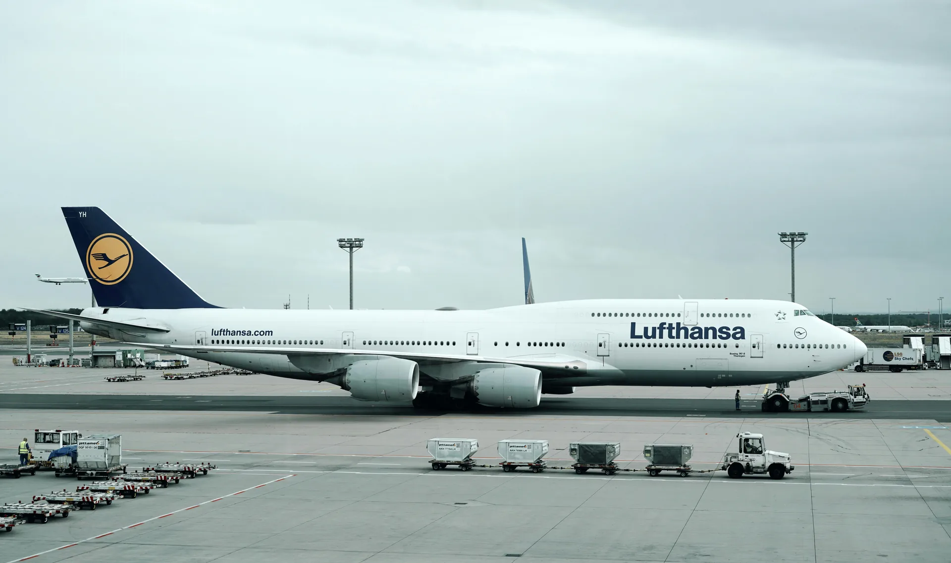 Lufthansa Boeing 747 on the apron at Frankfurt Airport with ground service vehicles