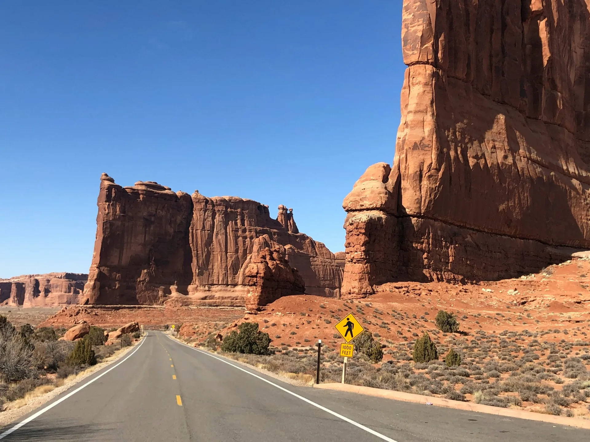 Scenic road through red sandstone towers in Arches National Park, Utah, USA